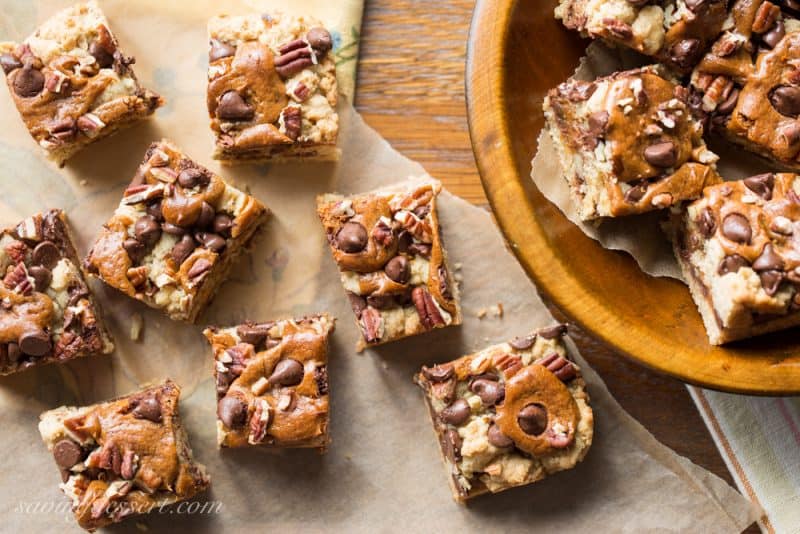 Chocolate Chip Oatmeal Carmelitas - loads of pecans, chocolate chips, and dollops of dulce de leche piled on an oatmeal crust, then baked into a delicious treat! Always a favorite cookie bar | www.savingdessert.com