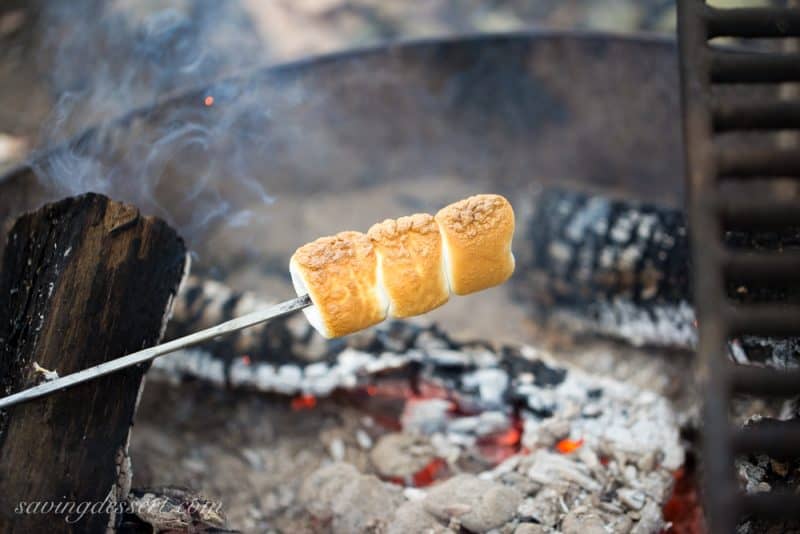 Roasted golden brown marshmallows over a campfire