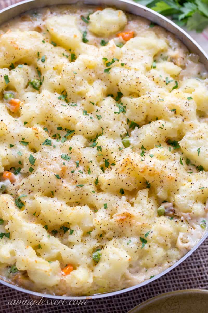 Skillet Chicken with Potatoes & Vegetables ~ comfort at it's best! A creamy sauce that reminds me of a pot pie with tender vegetables, and chunks of chicken topped with fluffy potatoes just like Shepherd's Pie! www.savingdessert.com