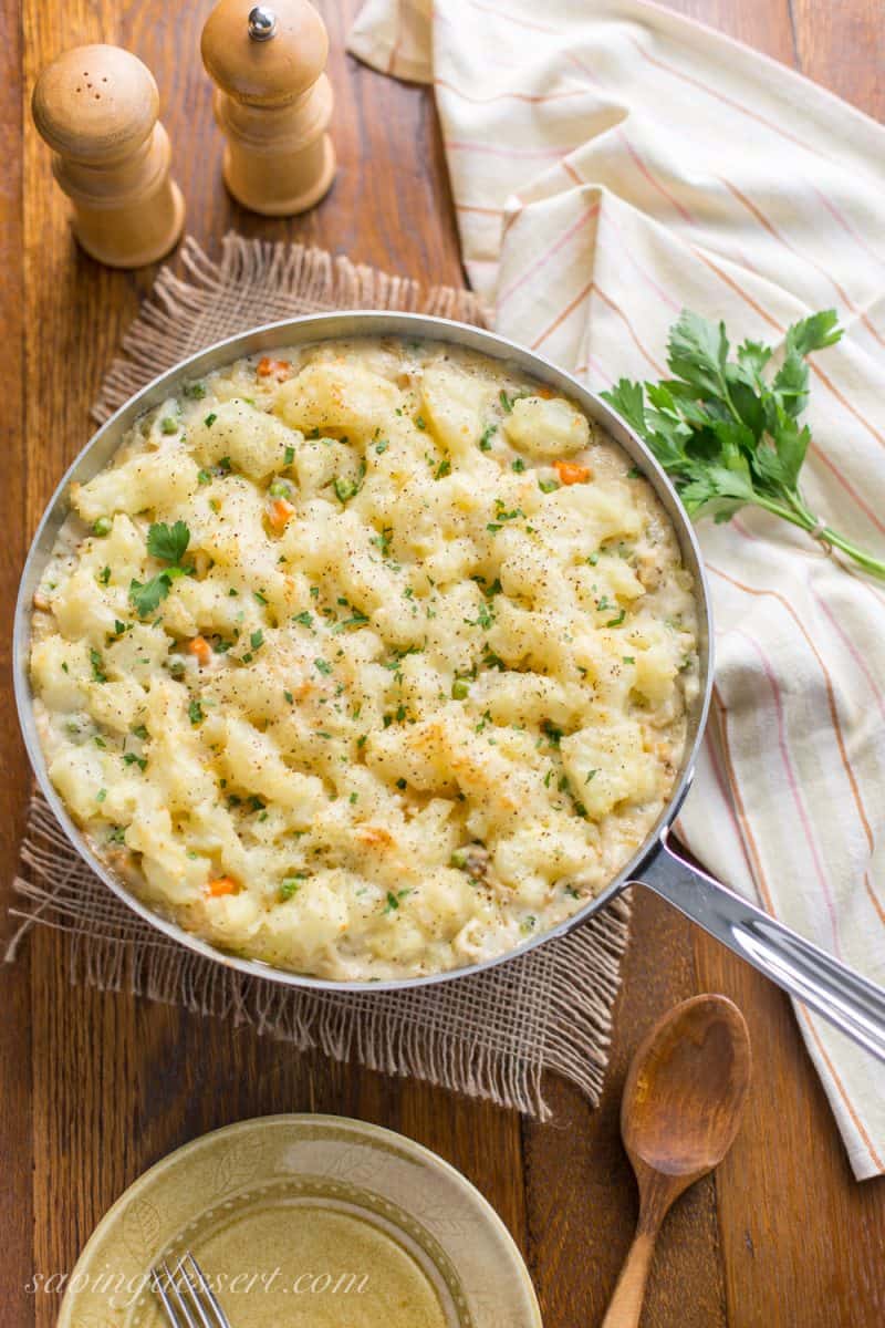 Skillet Chicken with Potatoes & Vegetables ~ comfort at it's best! A creamy sauce that reminds me of a pot pie with tender vegetables, and chunks of chicken topped with fluffy potatoes just like Shepherd's Pie! www.savingdessert.com
