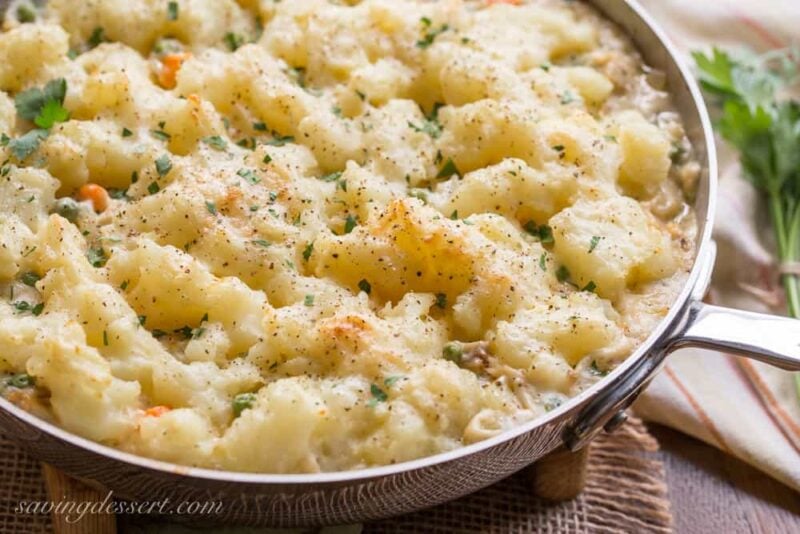 Skillet Chicken with Potatoes & Vegetables ~ comfort at it's best! A creamy sauce that reminds me of a pot pie with tender vegetables, and chunks of chicken topped with fluffy potatoes just like Shepherd's Pie! www.savingdessert.com