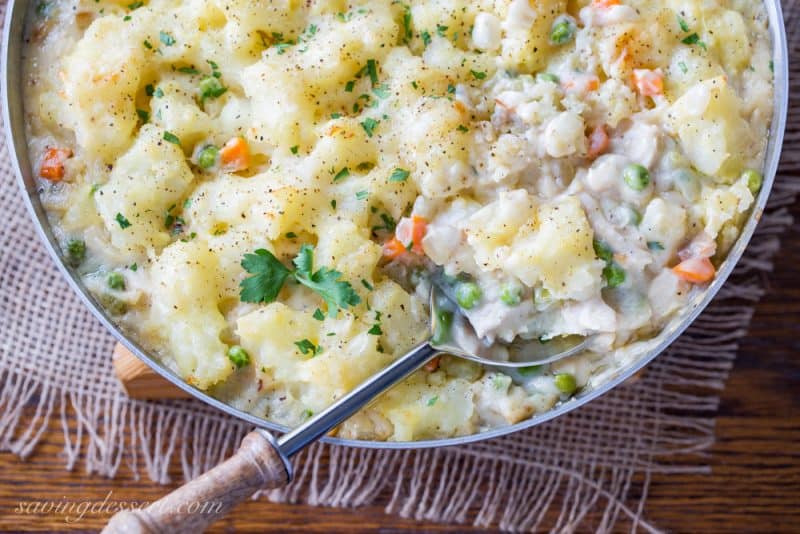 Skillet Chicken with Potatoes & Vegetables ~ comfort at it's best! A creamy sauce that reminds me of a pot pie with tender vegetables, and chunks of chicken topped with fluffy potatoes just like Shepherd's Pie! www.savingdessert.com