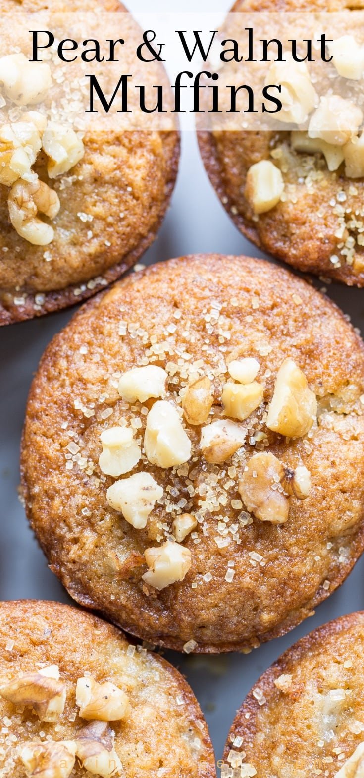Close-up shot of Pear and Walnut Muffins sprinkled with coarse sugar and chopped walnuts