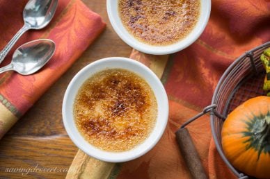 Two ramekins filled with pumpkin creme brûlée