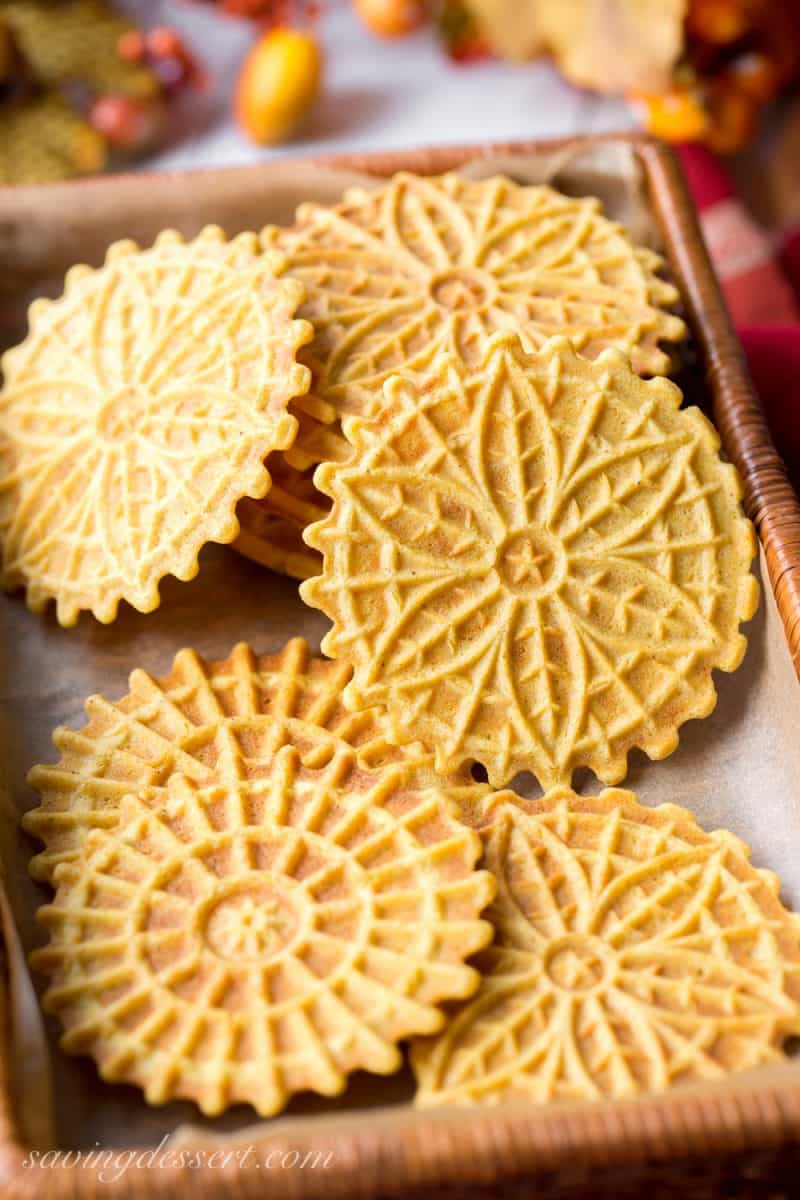 A basket filled with pumpkin flavored pizzelle cookies