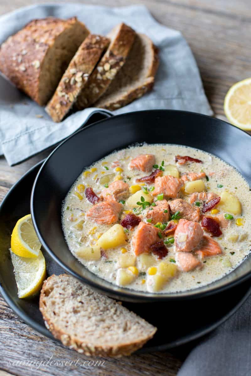 A bowl of salmon chowder with potatoes and bacon