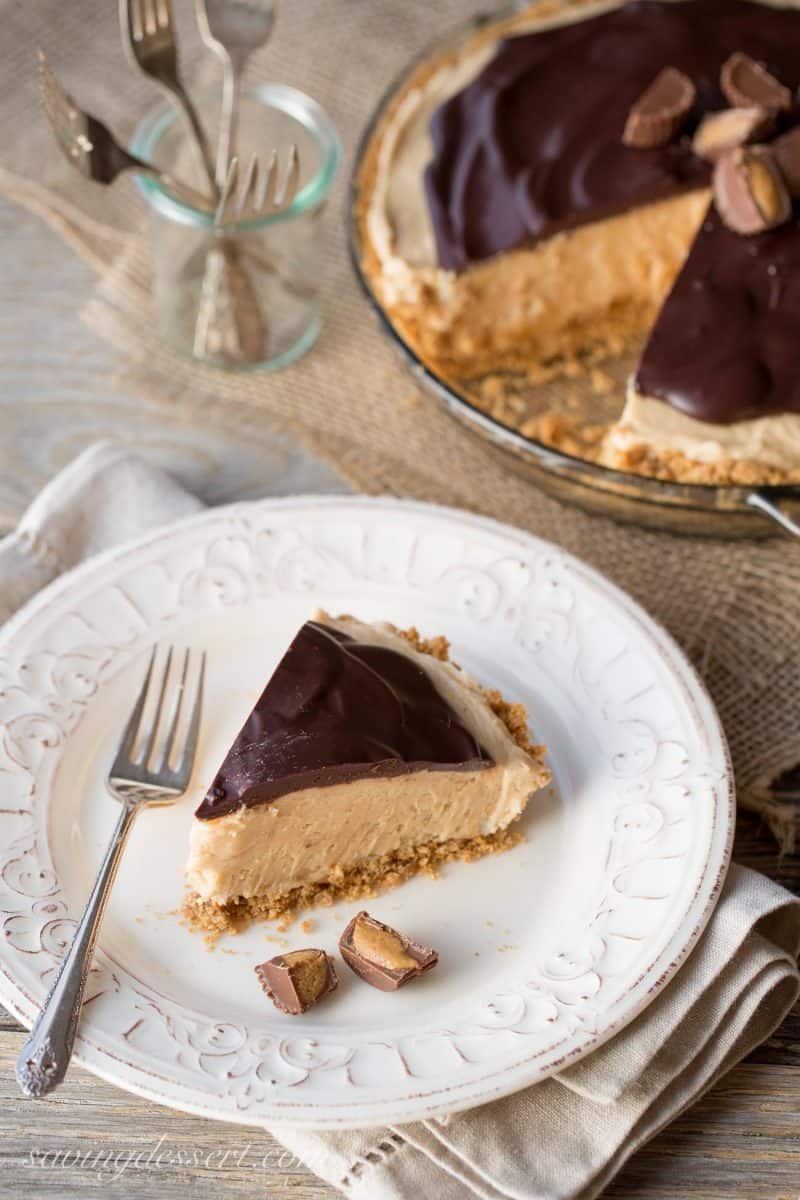 A slice of peanut butter pie with chocolate ganache and served with mini Reeses Cups.