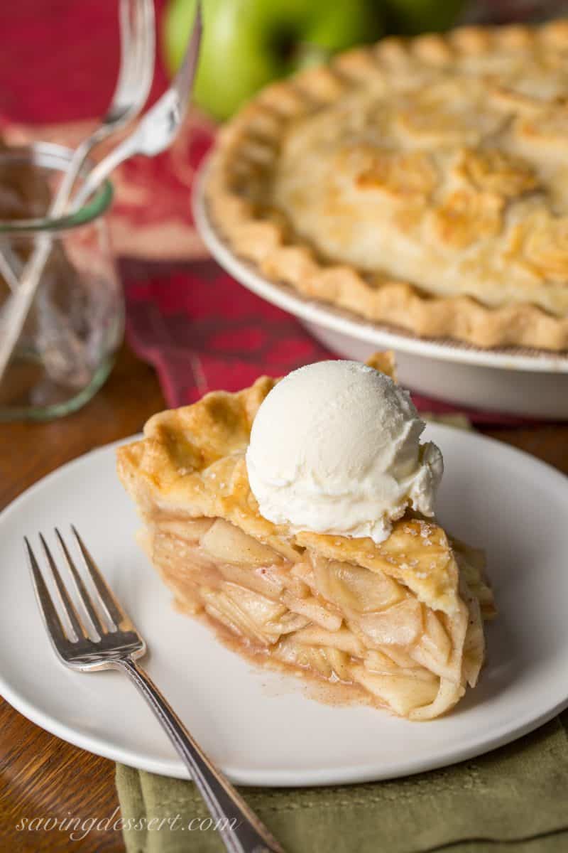 Classic Apple Pie - sliced with a scoop of vanilla ice cream on top