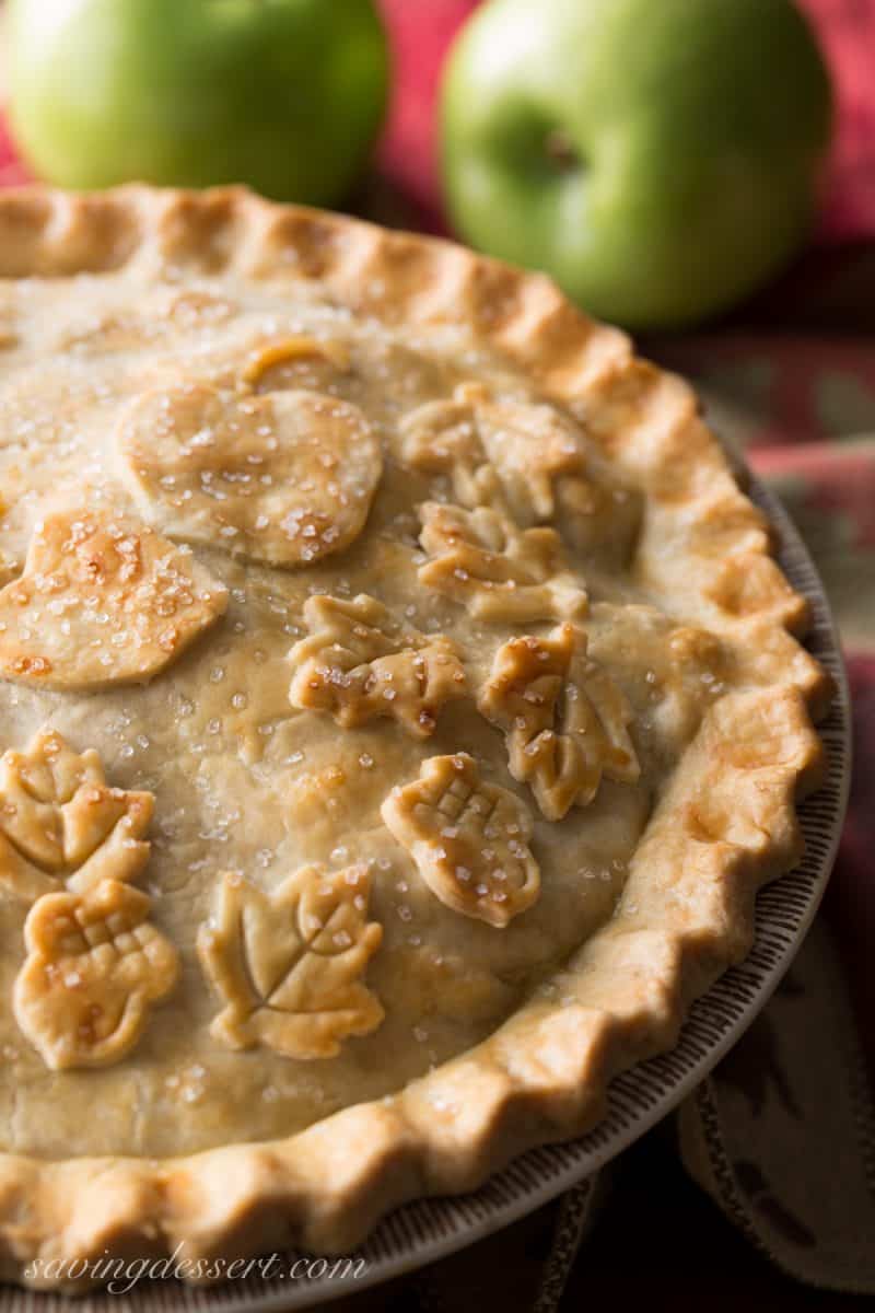 Classic Double Crust Apple Pie Recipe - the filling is made with tart, crisp apples then wrapped in a buttery, flaky pastry dough. Baked until golden brown then served warm with a scoop of ice cream. Nothing says home like apple pie! www.savingdessert.com