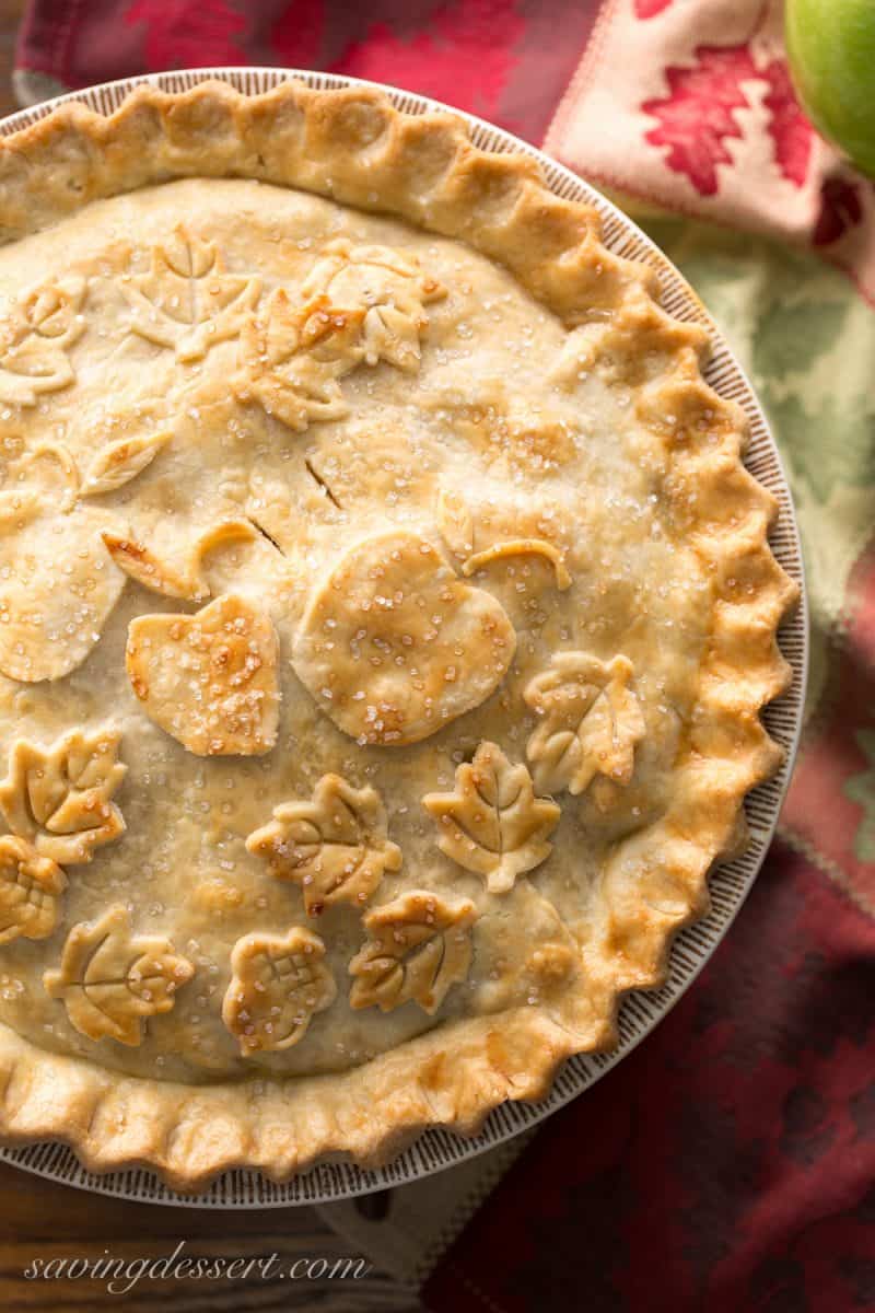 Classic Double Crust Apple Pie Recipe - the filling is made with tart, crisp apples then wrapped in a buttery, flaky pastry dough. Baked until golden brown then served warm with a scoop of ice cream. Nothing says home like apple pie! www.savingdessert.com