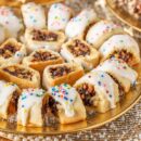 A plate of holiday Fig Cookies topped with icing and sprinkles