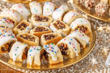 A plate of holiday Fig Cookies topped with icing and sprinkles