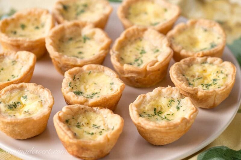 Mini Cheese Quiche Recipe - with a velvety smooth filling, rich flavor and a flaky crust - the perfect appetizer! www.savingdessert.com