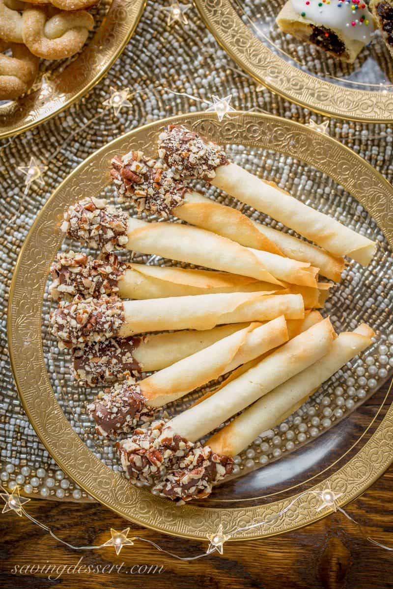 Tuile Cigar Cookies, also known as pirouettes, are crisp, delicate little cookies with a perfect vanilla flavor and buttery crunch. www.savingdessert.com