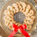 vanilla pretzel cookies laid out in a wreath pattern with a red bow