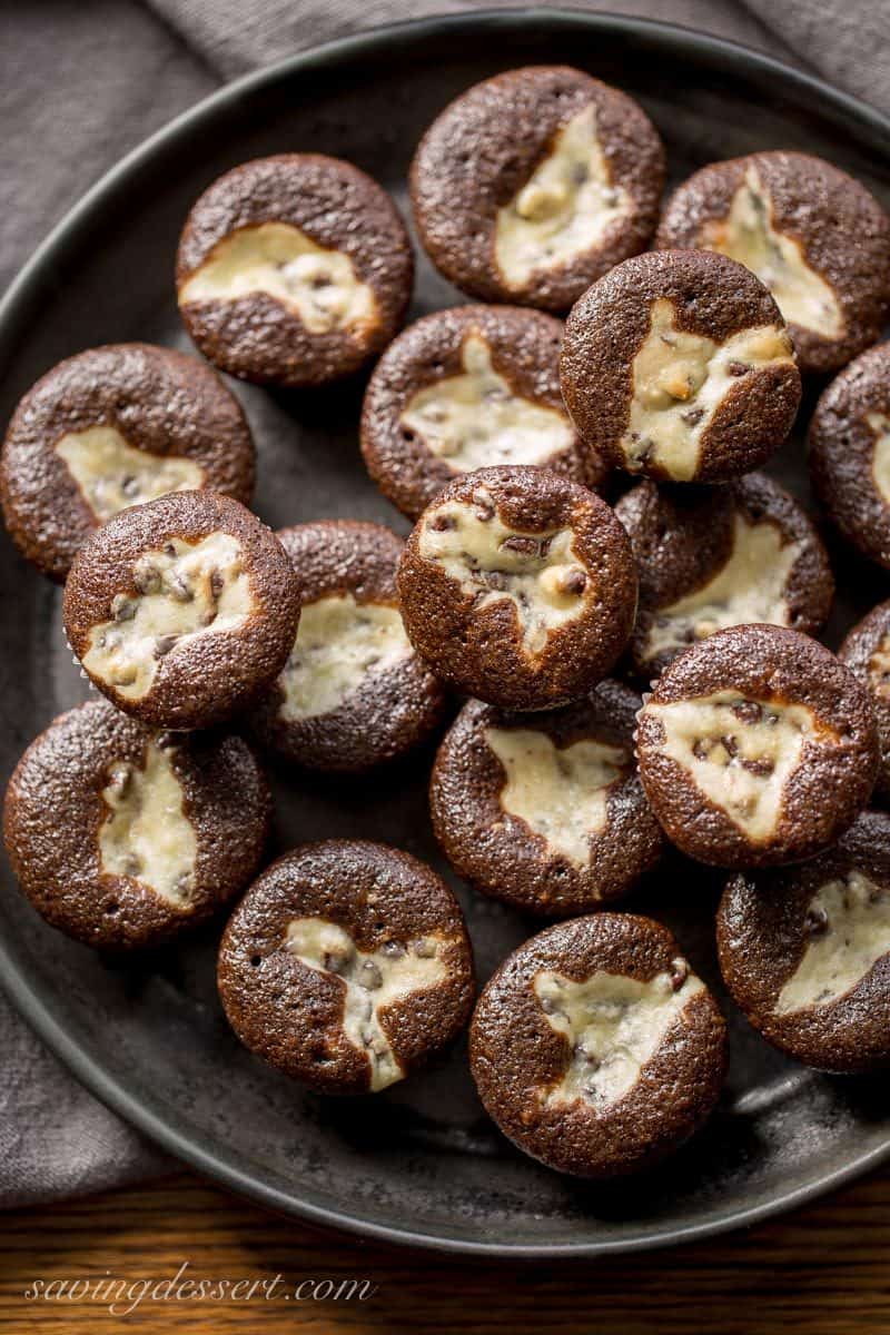 A plate of mini black bottoms - chocolate and cheesecake treats with mini chocolate chips