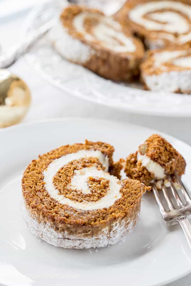 A sliced gingerbread roll cake on a place