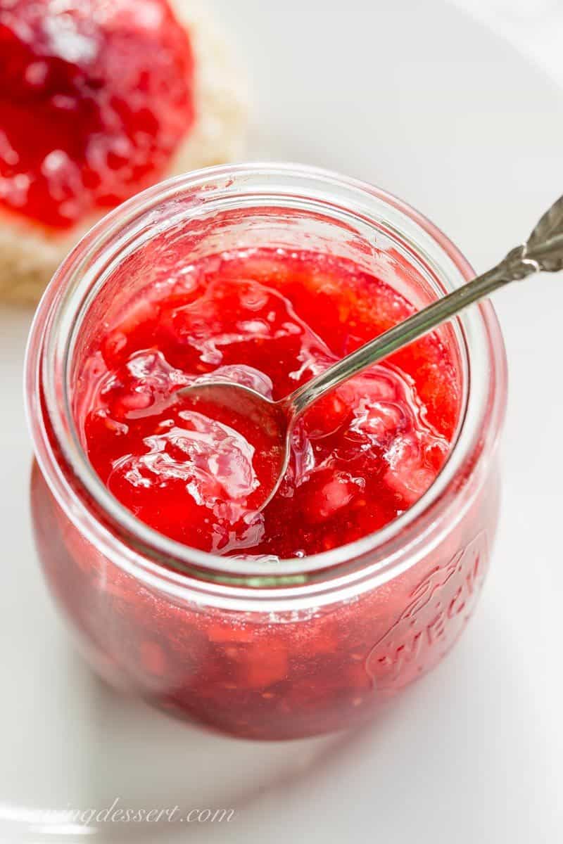 Holiday Jam ~ a wonderful combination of cranberries, raspberries, and pears with a touch of spice and a splash of Grand Marnier! This quick & easy freezer jam recipe will thrill you and your guests. Dressed up in a pretty jar, this makes a wonderful gift! www.savingdessert.com