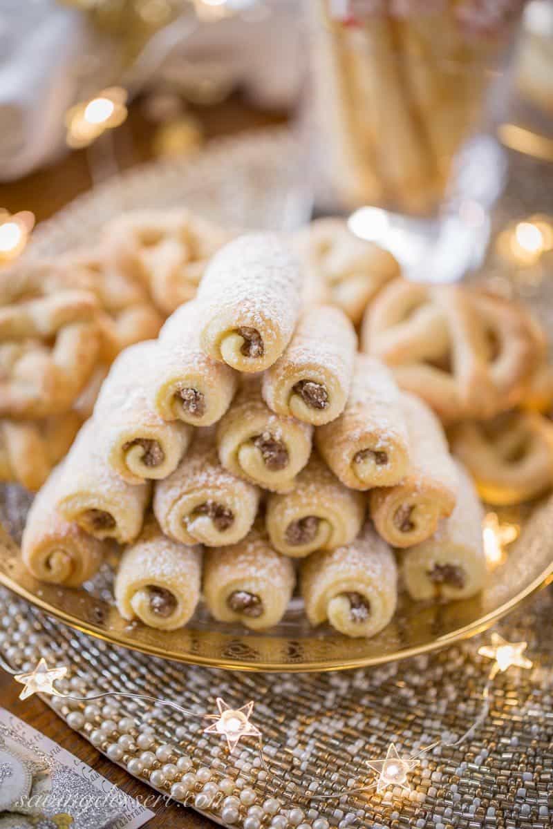 Roczki Cookies (Kolacky) are made with a tender, yeasted dough rolled up in a cigar shape with a simple, lemony, ground nut filling. www.savingdessert.com