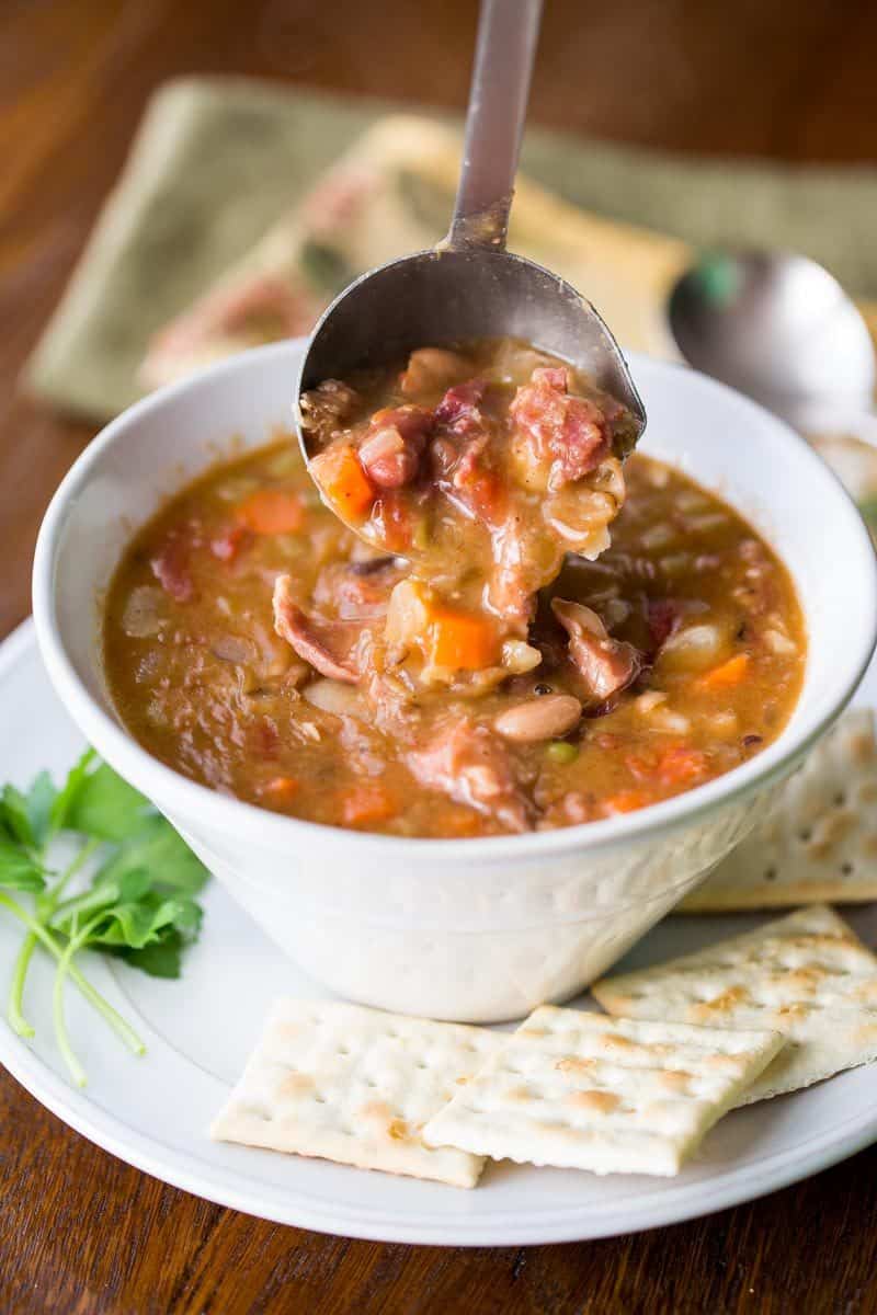 15 Bean Soup with Ham and Vegetables - a hearty, stick-to-your-ribs kind of soup loaded with heart healthy beans, fresh onions, diced tomatoes, celery, carrots and plenty of spices. This soup freezes beautifully! www.savingdessert.com