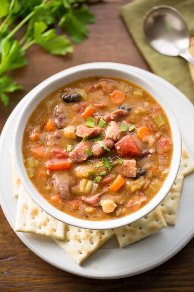 15 Bean Soup with Ham and Vegetables - a hearty, stick-to-your-ribs kind of soup loaded with heart healthy beans, fresh onions, diced tomatoes, celery, carrots and plenty of spices. This soup freezes beautifully! www.savingdessert.com