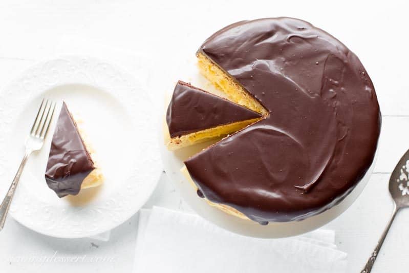 Classic Boston Cream Pie ~ moist, tender sponge cake filled with a layer of rich, smooth vanilla pastry cream, then topped with a delicious bittersweet chocolate glaze. | chocolate | Boston Cream Pie | Pastry Cream | chocolate ganache | www.savingdessert.com