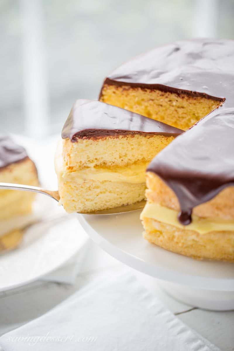 Classic Boston Cream Pie ~ moist, tender sponge cake filled with a layer of rich, smooth vanilla pastry cream, then topped with a delicious bittersweet chocolate glaze. | chocolate | Boston Cream Pie | Pastry Cream | chocolate ganache | www.savingdessert.com