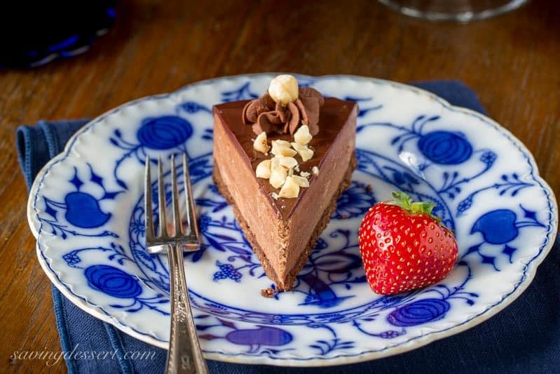 Chocolate Hazelnut Mousse Cake ~ a light and fluffy Nutella chocolate mousse spread over a chocolate hazelnut shortbread crust, topped with a simple chocolate ganache and garnished with chopped toasted hazelnuts. www.savingdessert.com