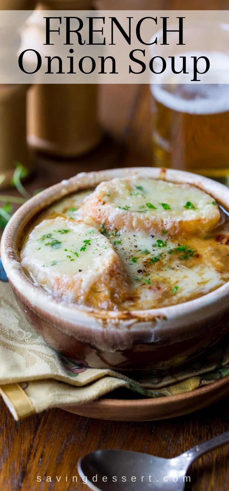 A bowl of French Onion Soup topped with baguette slices covered in melted cheese
