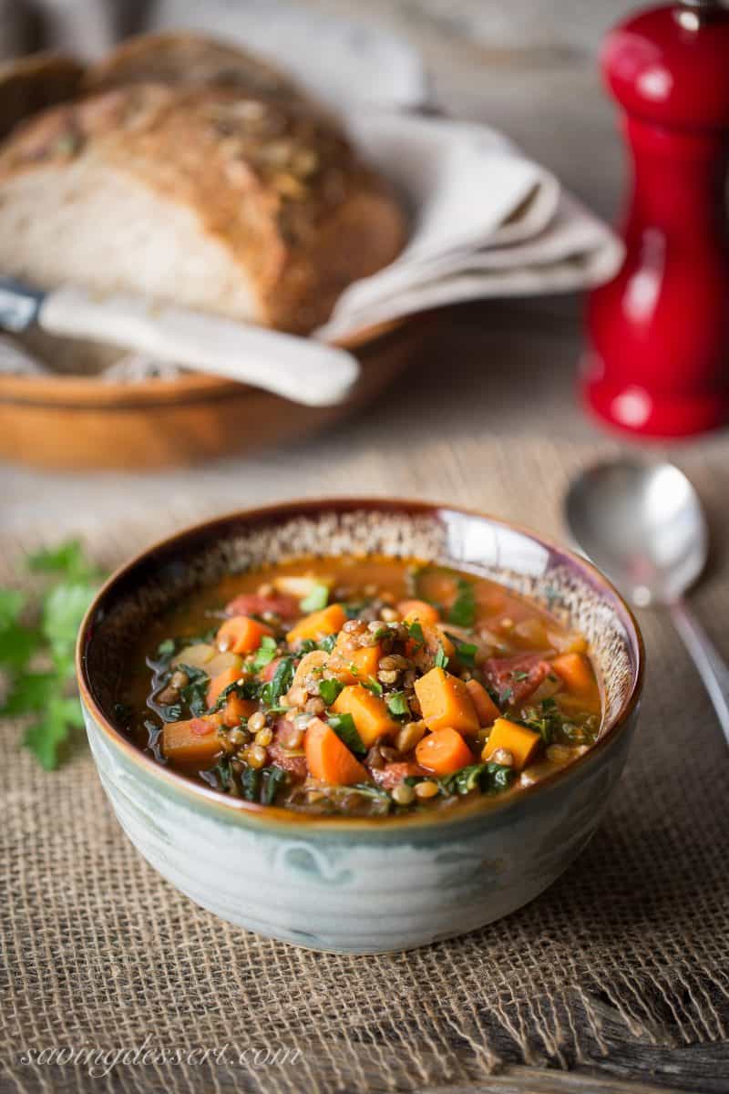 Vegetable Soup with Lentils & Seasonal Greens - a hearty rustic soup loaded with vegetables simmered in a rich flavorful broth with wilted seasonal greens and lentils. Lentils are a nutritional powerhouse full of fiber and protein and boast an impressive amount of folate, iron, phosphorus and potassium. Lentils make a great addition to most any soup, chili, and even salads. www.savingdessert.com