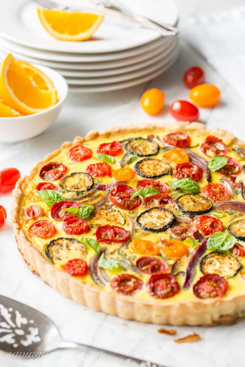 Farmers' Market Quiche - A tasty, fresh vegetable quiche filled with zucchini, onions, tomatoes and cheese. Fresh picked herbs and a flaky crust make this a wonderful addition to your brunch table! www.savingdessert.com