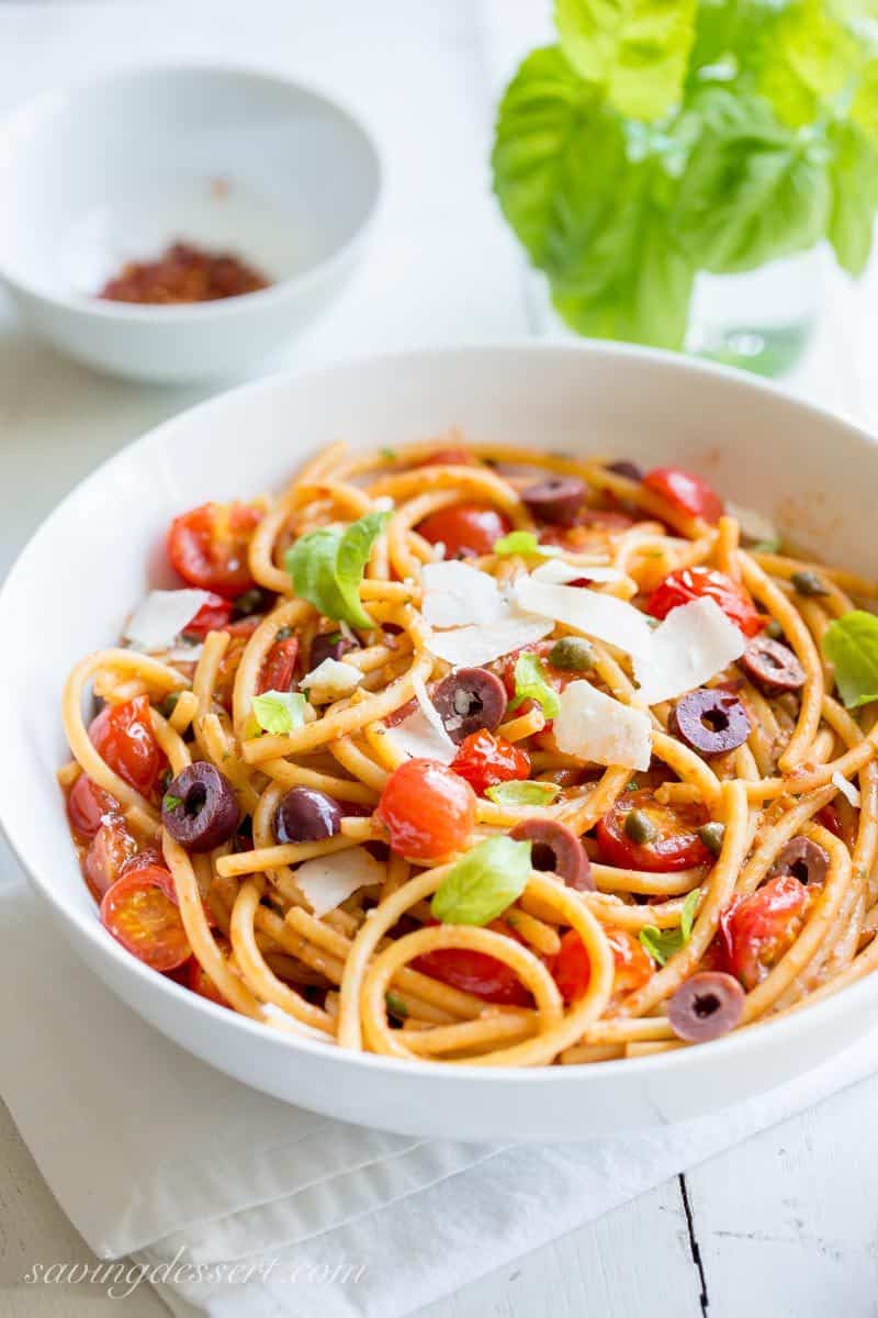 Bucatini Puttanesca ~ a deliciously easy one-pot pasta dish with a simple but zesty sauce and loads of fresh tomatoes, olives and capers. www.savingdessert.com anchovy | red pepper | bucatini pasta | spaghetti | cherry tomatoes | kalamata olives | capers | meatless monday