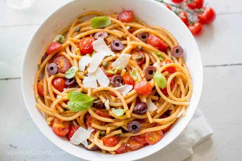 Bucatini Puttanesca ~ a deliciously easy one-pot pasta dish with a simple but zesty sauce and loads of fresh tomatoes, olives and capers. www.savingdessert.com anchovy | red pepper | bucatini pasta | spaghetti | cherry tomatoes | kalamata olives | capers | meatless monday