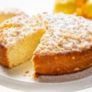 A single layer lemon cake with a sweet crumbled topping
