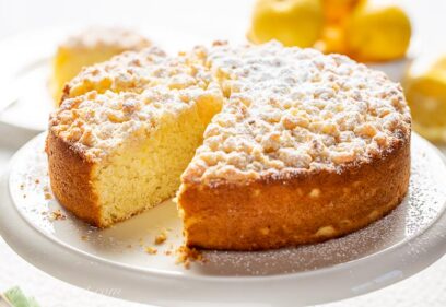 A single layer lemon cake with a sweet crumbled topping