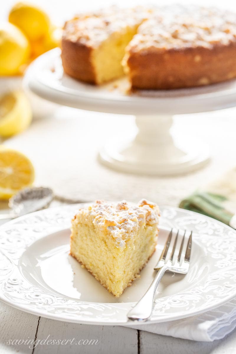 A slice of lemon cake on a plate with a fork