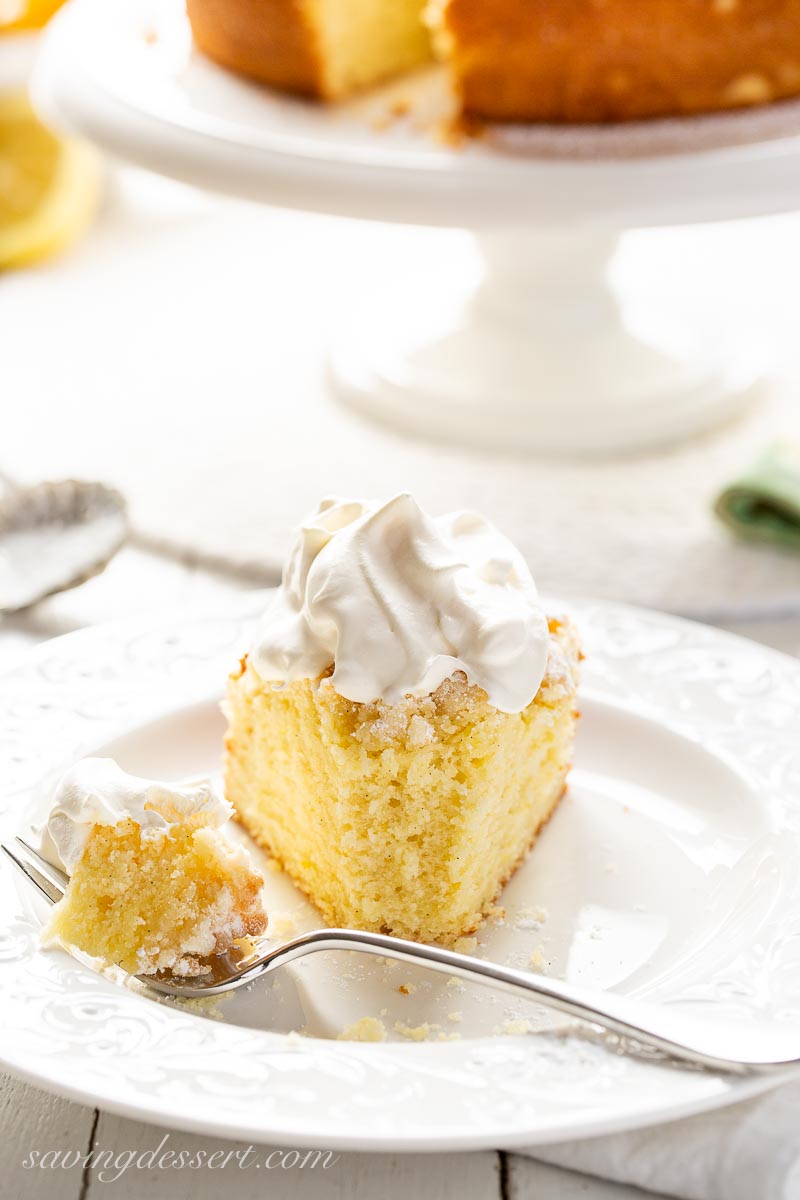 A slice of cake topped with whipping cream 