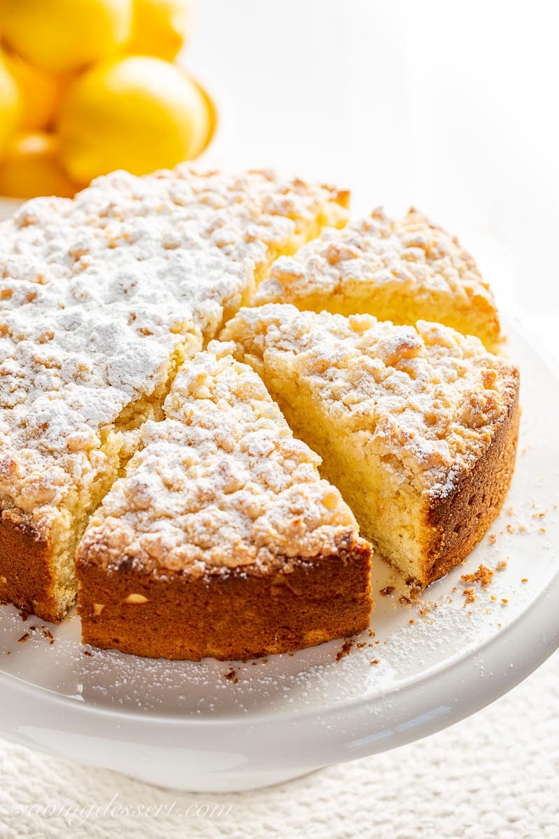 An overhead photo of a sliced lemon cake on a cake stand