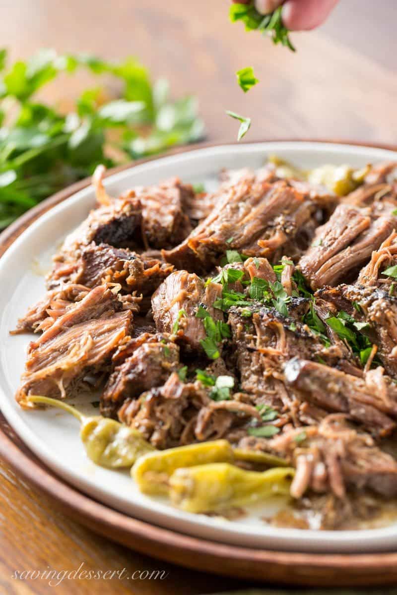 Mississippi Pot Roast - a tender, well flavored slow cooker pot roast with pepperoncini peppers and a simple homemade ranch dressing. The briny little peppers add a spicy punch of flavor, and it couldn't be easier to make! www.savingdessert.com