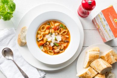 A bowl of Winter Minestrone Soup with bread on the side