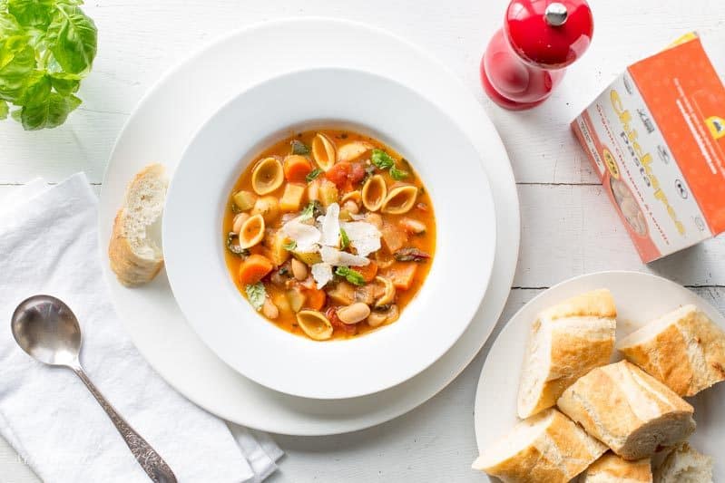 A bowl of Winter Minestrone Soup with bread on the side