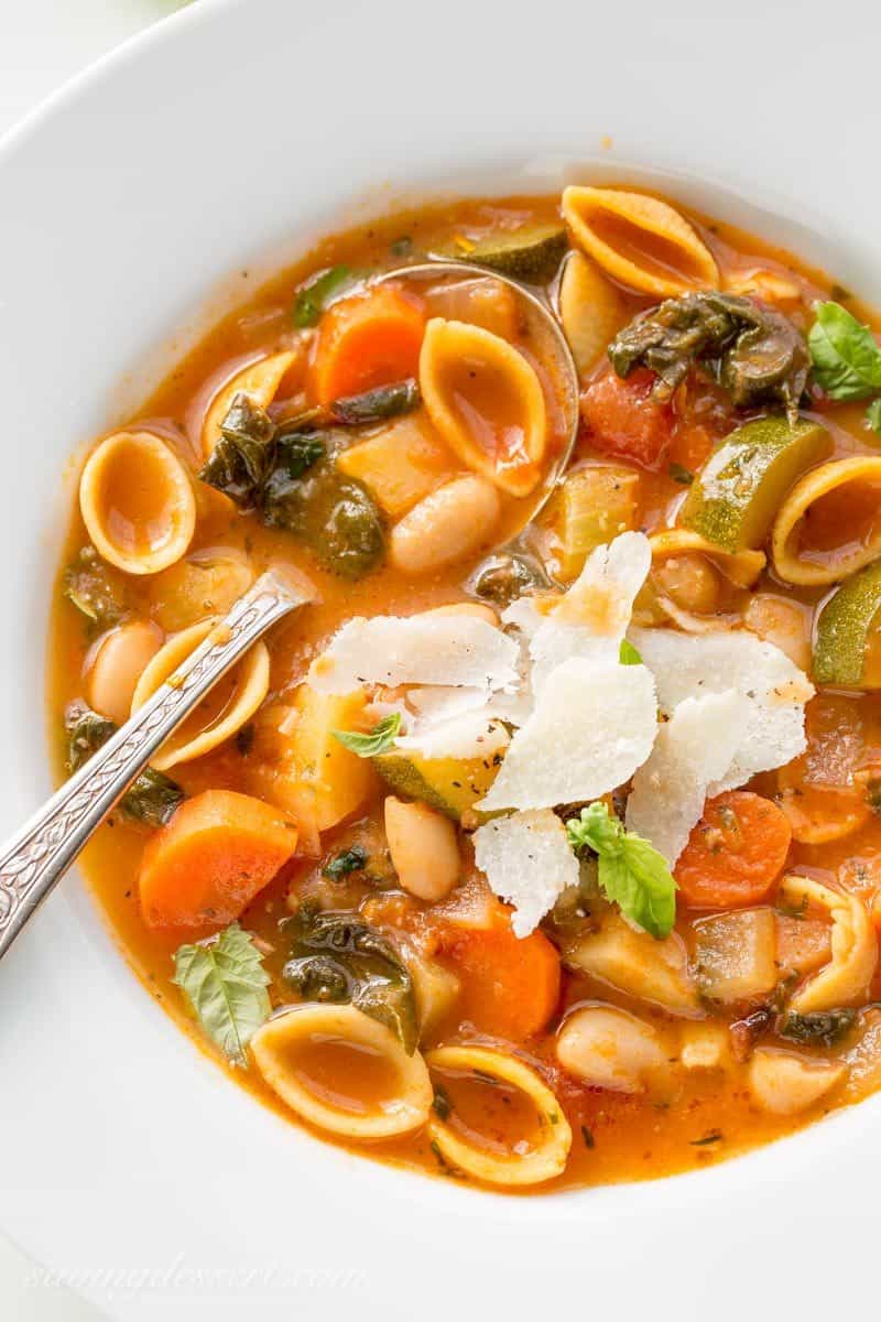 A bowl of Winter Minestrone Soup with fresh grated Parmesan on top