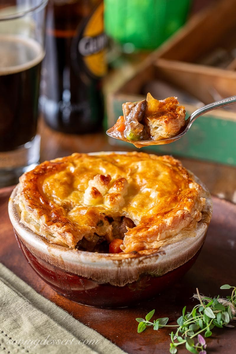 A spoonful of Irish beef pie with puff pastry on top
