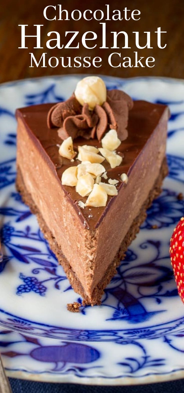 A slice of chocolate hazelnut mousse cake with chopped nuts on top