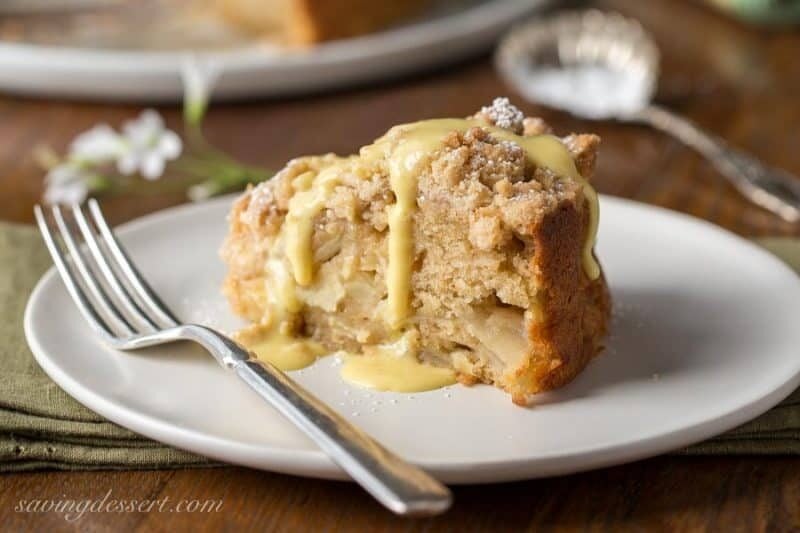 Irish Apple Crumble Cake with Apple Brandy Sauce ~ made with fresh apples, plenty of cinnamon, and a sweet crumble top, this rustic and moist cake is homey and delightful especially when drizzled with the Apple Brandy Sauce! www.savingdessert.com