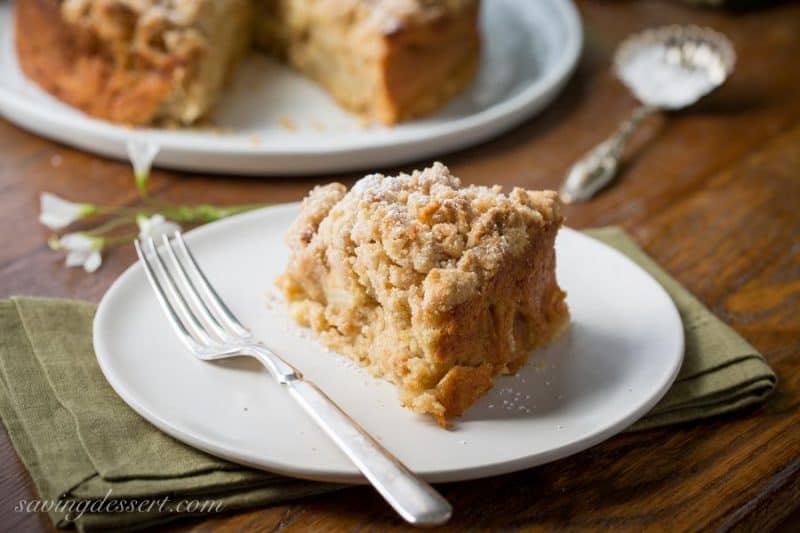 Irish Apple Crumble Cake with Apple Brandy Sauce ~ made with fresh apples, plenty of cinnamon, and a sweet crumble top, this rustic and moist cake is homey and delightful especially when drizzled with the Apple Brandy Sauce! www.savingdessert.com