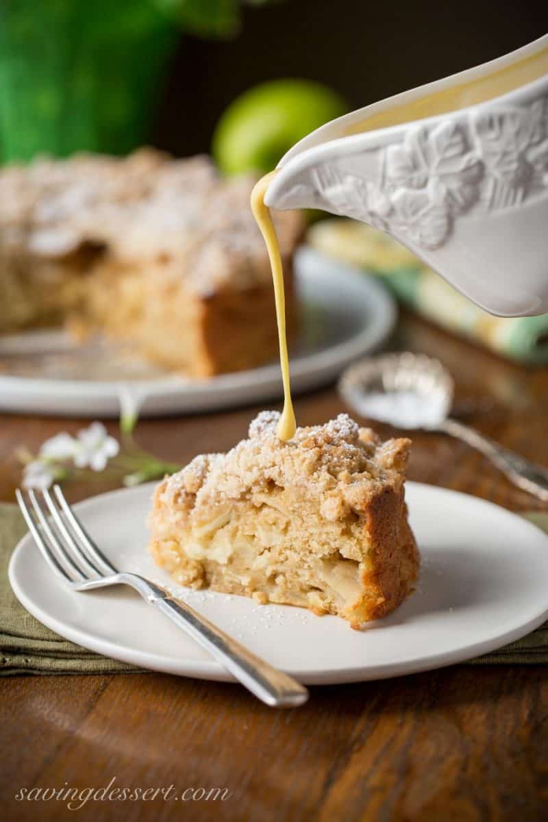 Irish Apple Crumble Cake with Apple Brandy Sauce ~ made with fresh apples, plenty of cinnamon, and a sweet crumble top, this rustic and moist cake is homey and delightful especially when drizzled with the Apple Brandy Sauce! www.savingdessert.com