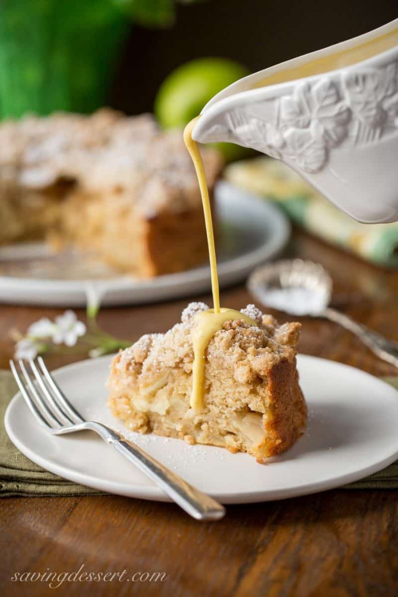 Irish Apple Crumble Cake with Apple Brandy Sauce ~ made with fresh apples, plenty of cinnamon, and a sweet crumble top, this rustic and moist cake is homey and delightful especially when drizzled with the Apple Brandy Sauce! www.savingdessert.com