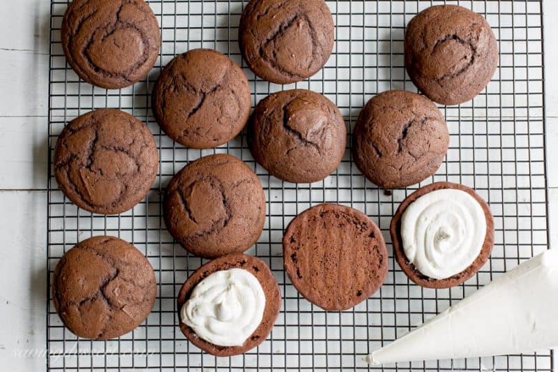 Classic Whoopie Pies ~ Chocolate cake-like batter is baked into large, soft hamburger-sized, bun shaped cookies then filled with a fluffy, sweet marshmallow frosting. www.savingdessert.com