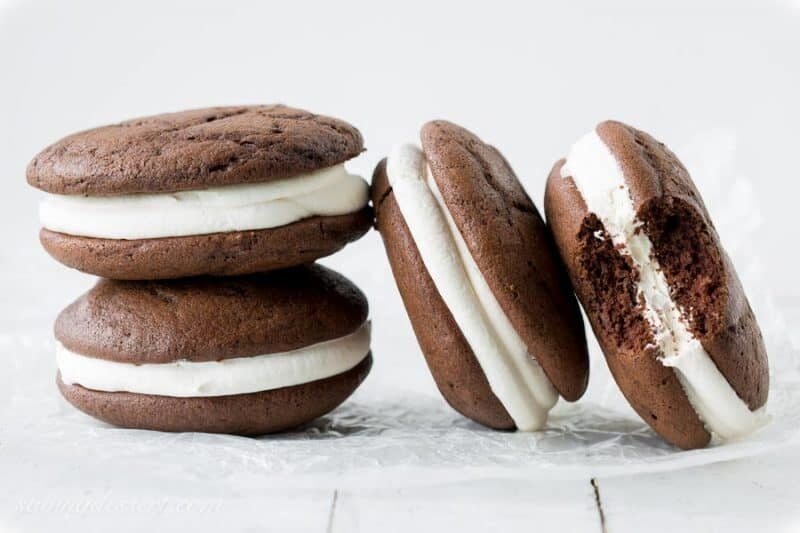 Classic Whoopie Pies ~ Chocolate cake-like batter is baked into large, soft hamburger-sized, bun shaped cookies then filled with a fluffy, sweet marshmallow frosting. www.savingdessert.com